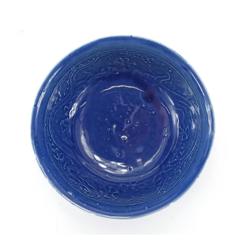 457 - Chinese blue glazed footed bowl decorated in low relief with two dragons, 19.5cm in diameter