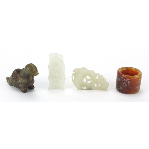 498 - Chinese jade carvings including a mythical animal, thumb ring and a pendant carved with a dragon, th... 