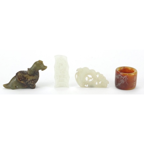 498 - Chinese jade carvings including a mythical animal, thumb ring and a pendant carved with a dragon, th... 