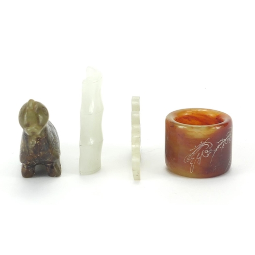 498 - Chinese jade carvings including a mythical animal, thumb ring and a pendant carved with a dragon, th... 