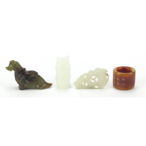 498 - Chinese jade carvings including a mythical animal, thumb ring and a pendant carved with a dragon, th... 