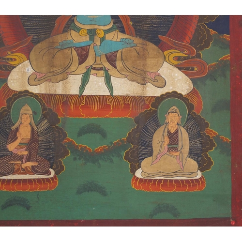 540 - Two Tibetan watercolour on silk Thang-Ga, both with deities, the largest 70cm x 49cm