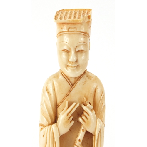 503 - Chinese carved ivory okimono of a gentleman holding a scroll, on hardwood stand, 22cm high