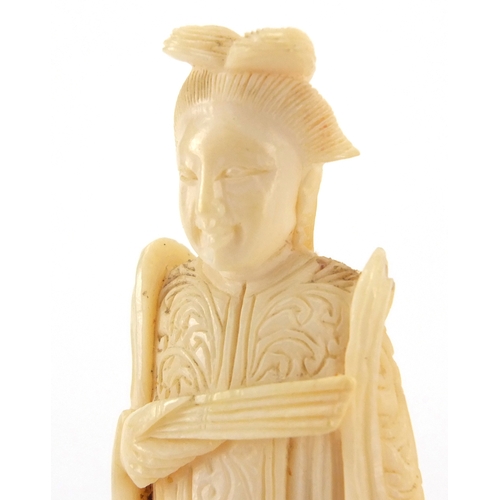 508 - Two Chinese carved ivory chess pieces, and Emperor and an Empress, each approximately 8cm high