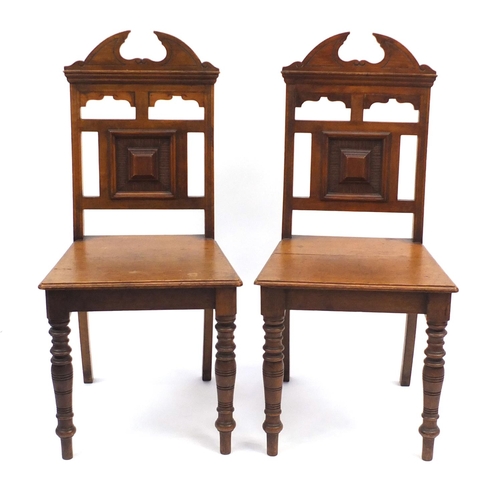2035 - Edwardian pair of carved oak hall chairs, 95cm H
