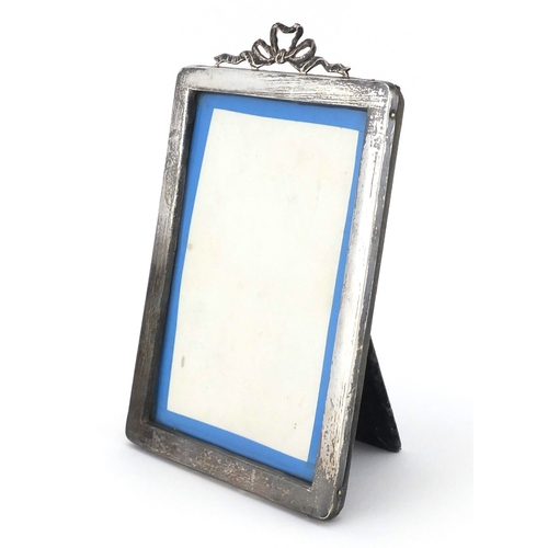 744 - Rectangular silver easel photo frame with bow crest, HM Chester indistinct date letter, 19cm x 12.5c... 