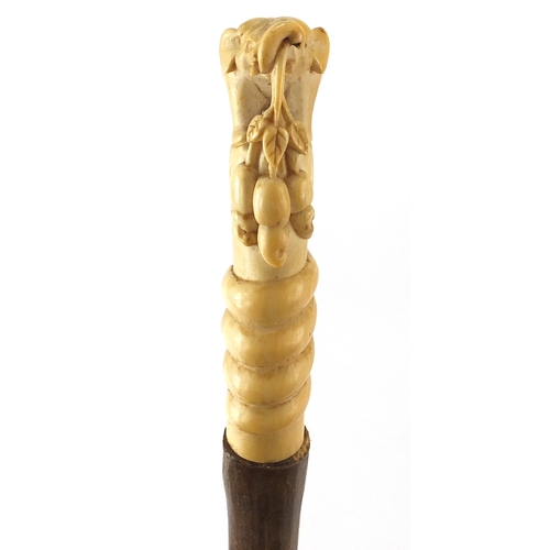 134 - Elephant whip with ivory handle, carved in the form of an elephant standing upon a cobra, 79cm in le... 