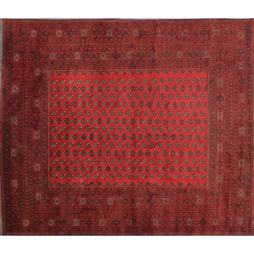 2015 - Rectangular Afghan carpet having an all over geometric design onto a red ground, 390cm x 310cm