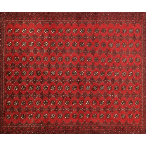 2015 - Rectangular Afghan carpet having an all over geometric design onto a red ground, 390cm x 310cm
