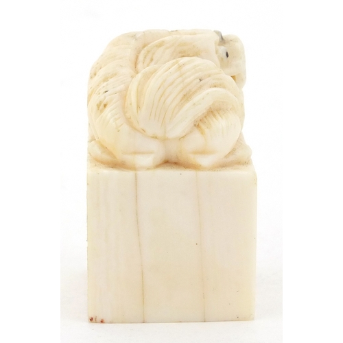 509 - Chinese ivory desk seal carved with a dog of foo, character marks to the base, 4.2cm high