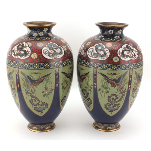 480 - Pair of Japanese cloisonné vases, both enamelled with panels of birds of paradise, the shoulders wit... 