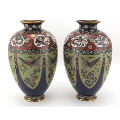 480 - Pair of Japanese cloisonné vases, both enamelled with panels of birds of paradise, the shoulders wit... 