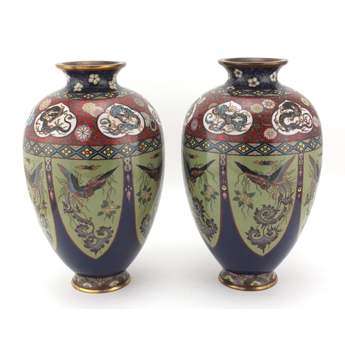 480 - Pair of Japanese cloisonné vases, both enamelled with panels of birds of paradise, the shoulders wit... 