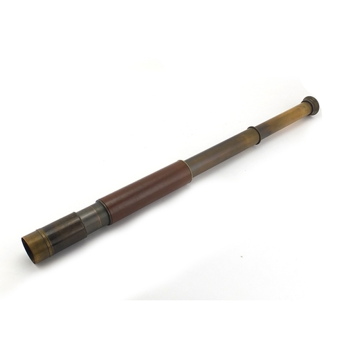 124 - Military interest two drawer brass telescope, leather bound, 26cm in length when closed