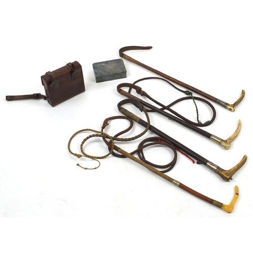 135 - Four riding crops together with a leather cased silver plated travelling container, two of the ridin... 