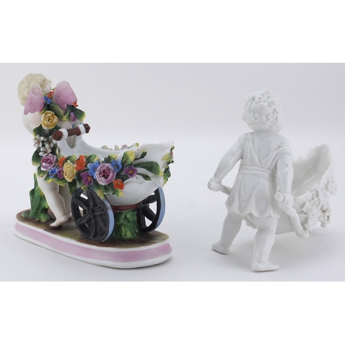 589 - Two 19th century porcelain cherubs, one hand painted and with floral encrusted decoration, the other... 