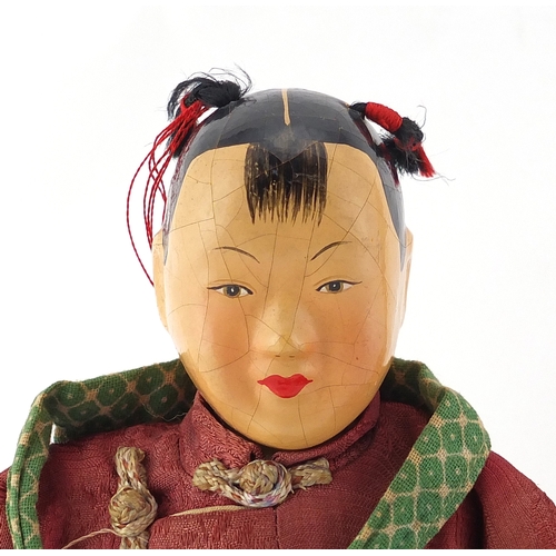 519 - Two Chinese bowls including a hand painted paper mache boy in traditional dress, the largest 25cm in... 