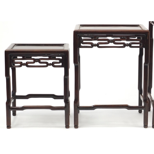 463a - Chinese rosewood quartetto nest of occasional tables, each with pierced carving, the largest 71.5cm ... 