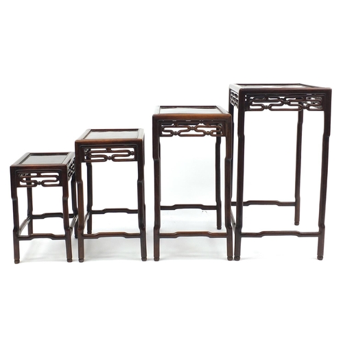 463a - Chinese rosewood quartetto nest of occasional tables, each with pierced carving, the largest 71.5cm ... 