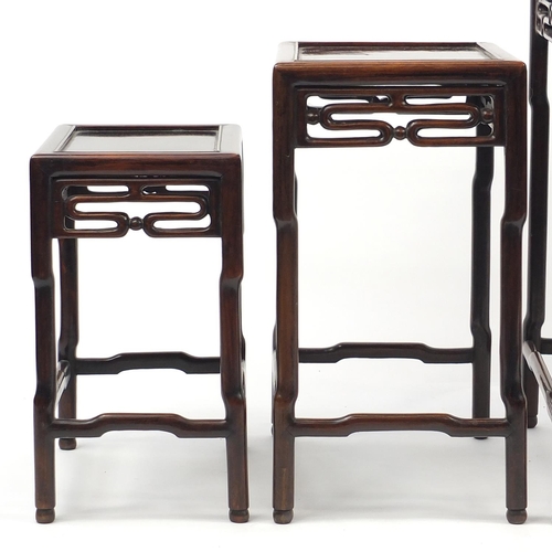 463a - Chinese rosewood quartetto nest of occasional tables, each with pierced carving, the largest 71.5cm ... 