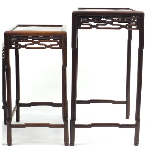 463a - Chinese rosewood quartetto nest of occasional tables, each with pierced carving, the largest 71.5cm ... 