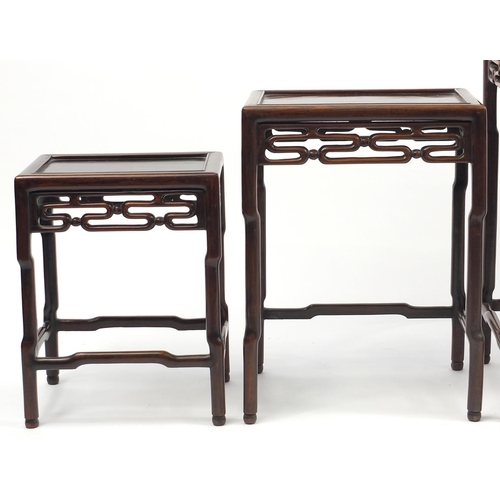 463a - Chinese rosewood quartetto nest of occasional tables, each with pierced carving, the largest 71.5cm ... 