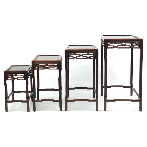 463a - Chinese rosewood quartetto nest of occasional tables, each with pierced carving, the largest 71.5cm ... 