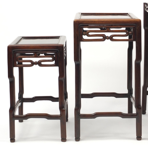 463a - Chinese rosewood quartetto nest of occasional tables, each with pierced carving, the largest 71.5cm ... 