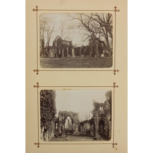 167 - Victorian social history black and white photographs arranged an album including street scenes, cath... 