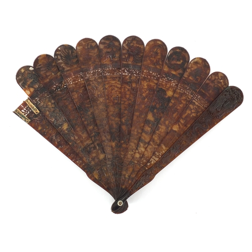 518 - Chinese canton Tortoiseshell fan, finely carved with figures amongst pagodas and dragons, 19cm in le... 