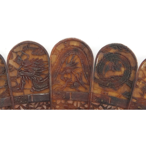 518 - Chinese canton Tortoiseshell fan, finely carved with figures amongst pagodas and dragons, 19cm in le... 