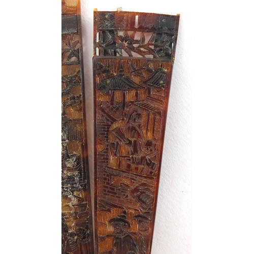 518 - Chinese canton Tortoiseshell fan, finely carved with figures amongst pagodas and dragons, 19cm in le... 