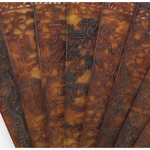 518 - Chinese canton Tortoiseshell fan, finely carved with figures amongst pagodas and dragons, 19cm in le... 