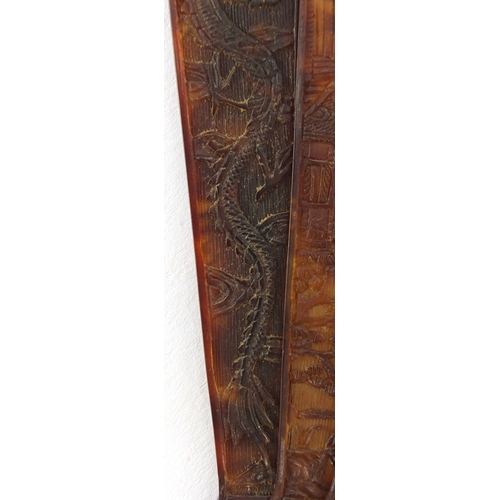 518 - Chinese canton Tortoiseshell fan, finely carved with figures amongst pagodas and dragons, 19cm in le... 