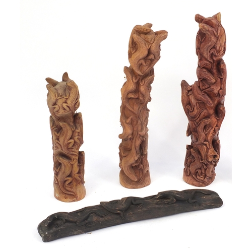 199A - Six carved wood lizard groups, the largest 63cm high