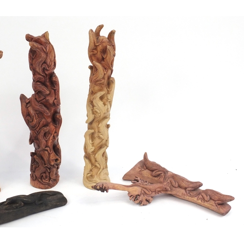 199A - Six carved wood lizard groups, the largest 63cm high