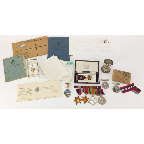 696 - British Military interest World War II medals with paperwork, a compass and two Masonic medals