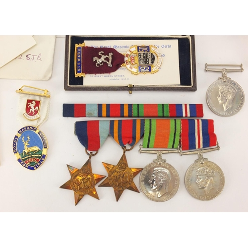 696 - British Military interest World War II medals with paperwork, a compass and two Masonic medals