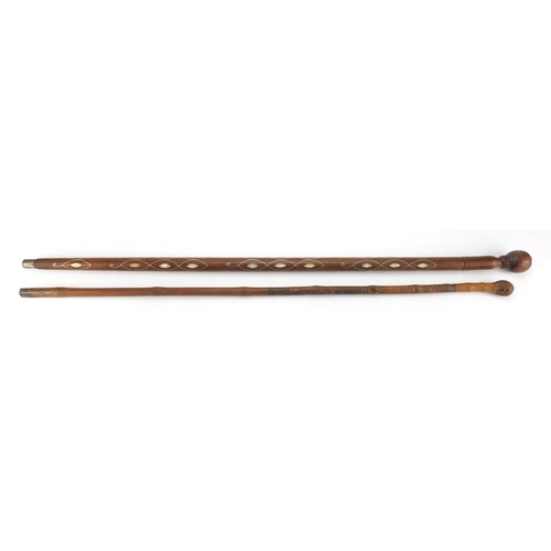 425 - Hardwood walking cane, possibly from the Pacific Islands with Mother of Pearl and silver coloured me... 