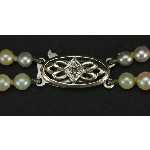 2458 - Two row pearl necklace with 9ct white gold diamond clasp, 40cm in length, approximate weight 25.3g