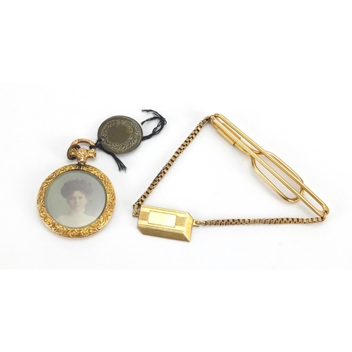 2463 - 9ct gold circular mourning locket and a gold coloured metal tie slide