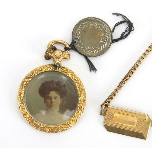 2463 - 9ct gold circular mourning locket and a gold coloured metal tie slide