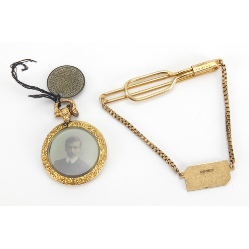 2463 - 9ct gold circular mourning locket and a gold coloured metal tie slide