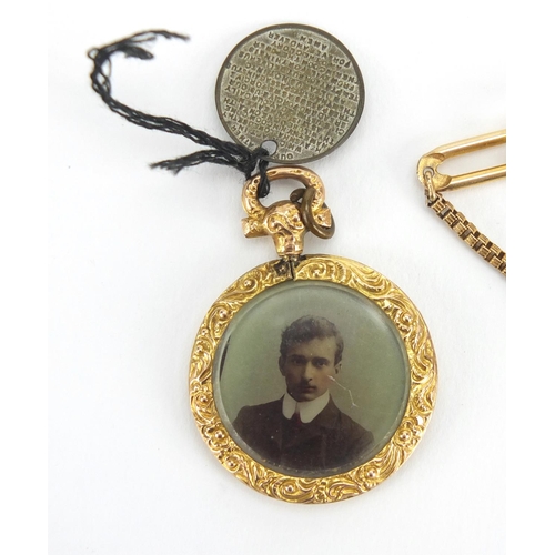 2463 - 9ct gold circular mourning locket and a gold coloured metal tie slide