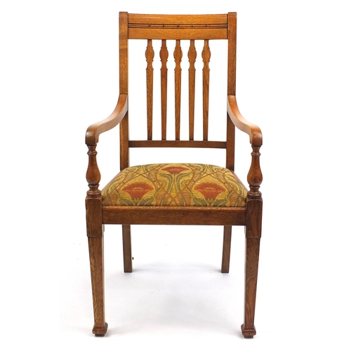 2016 - Oak Arts & Crafts open armchair the padded seat with stylised floral upholstery, 106cm high