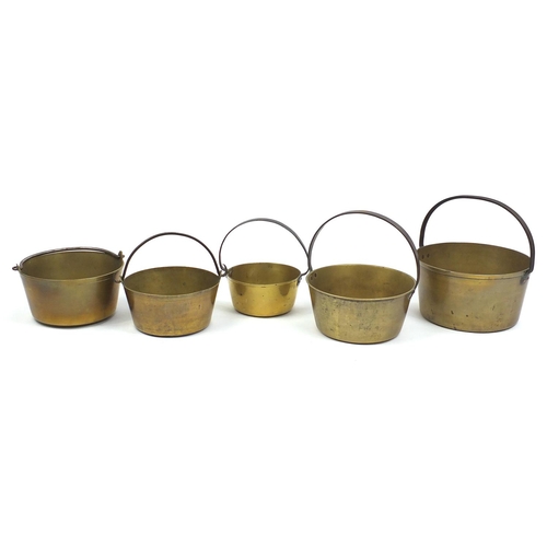 2060 - Five brass preserve pans with iron handles, the largest 37cm high