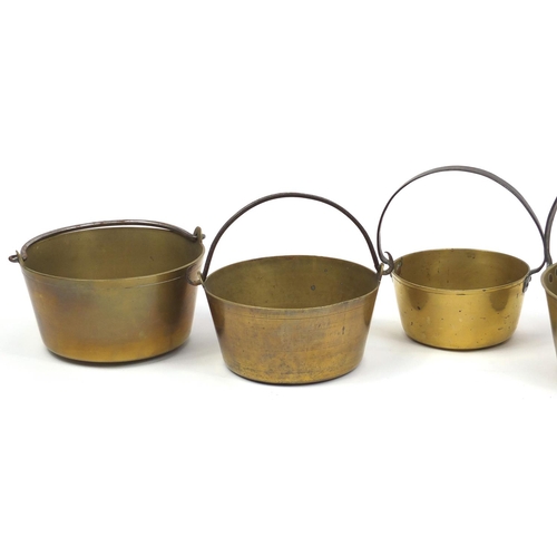 2060 - Five brass preserve pans with iron handles, the largest 37cm high