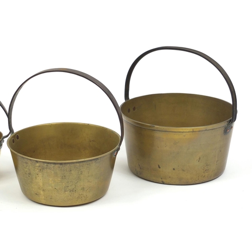 2060 - Five brass preserve pans with iron handles, the largest 37cm high