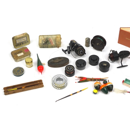 565 - Vintage fishing tackle including floats, lures and reels