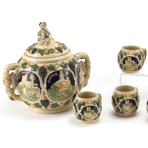 578 - German twin handled pottery server with eight cups, each decorated with various German views, the la... 